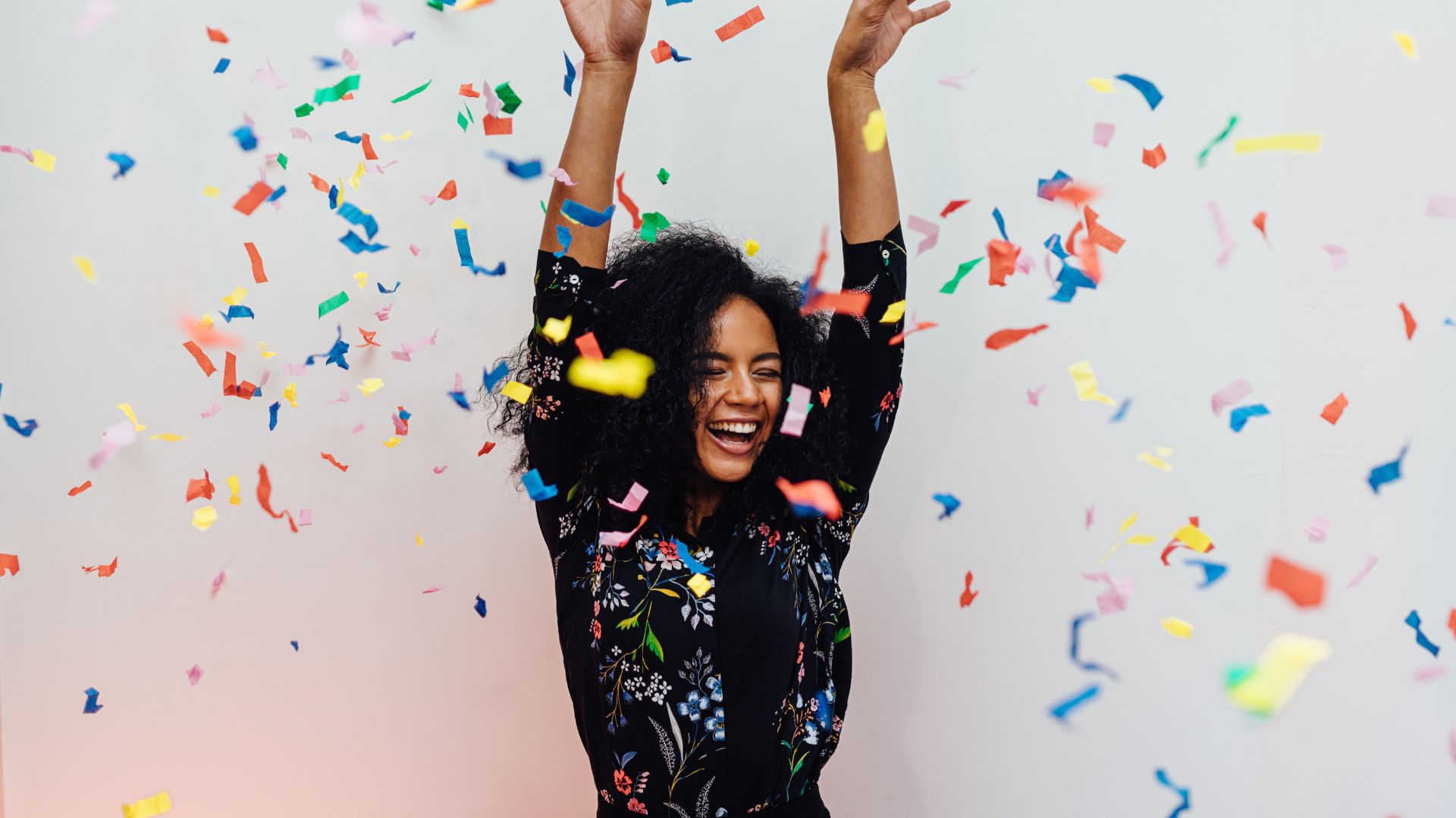Young lady smiling with confetti falling